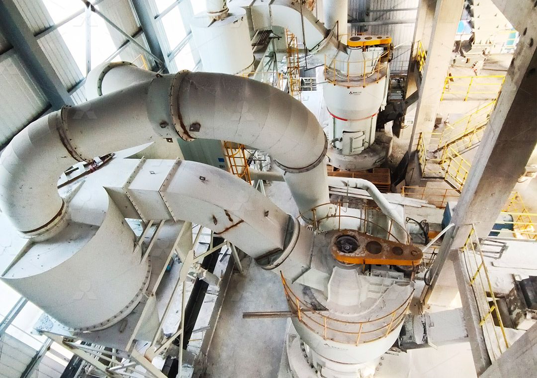 River gravel being fed into a grinding mill hopper